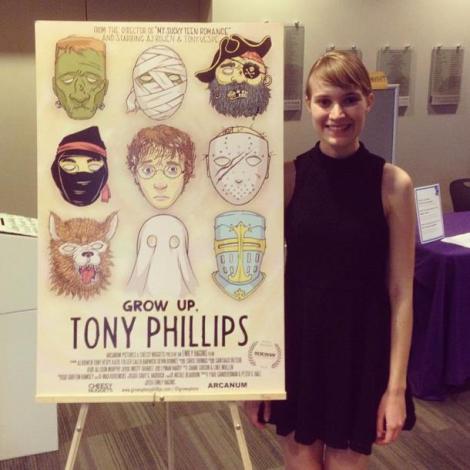 Writer/director Emily Hagins stands next to the poster of her new film, “Grow Up, Tony Phillips.” Courtesy of Emily Hagins.